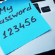 A sticky note on a laptop keyboard reading "my password 123456"